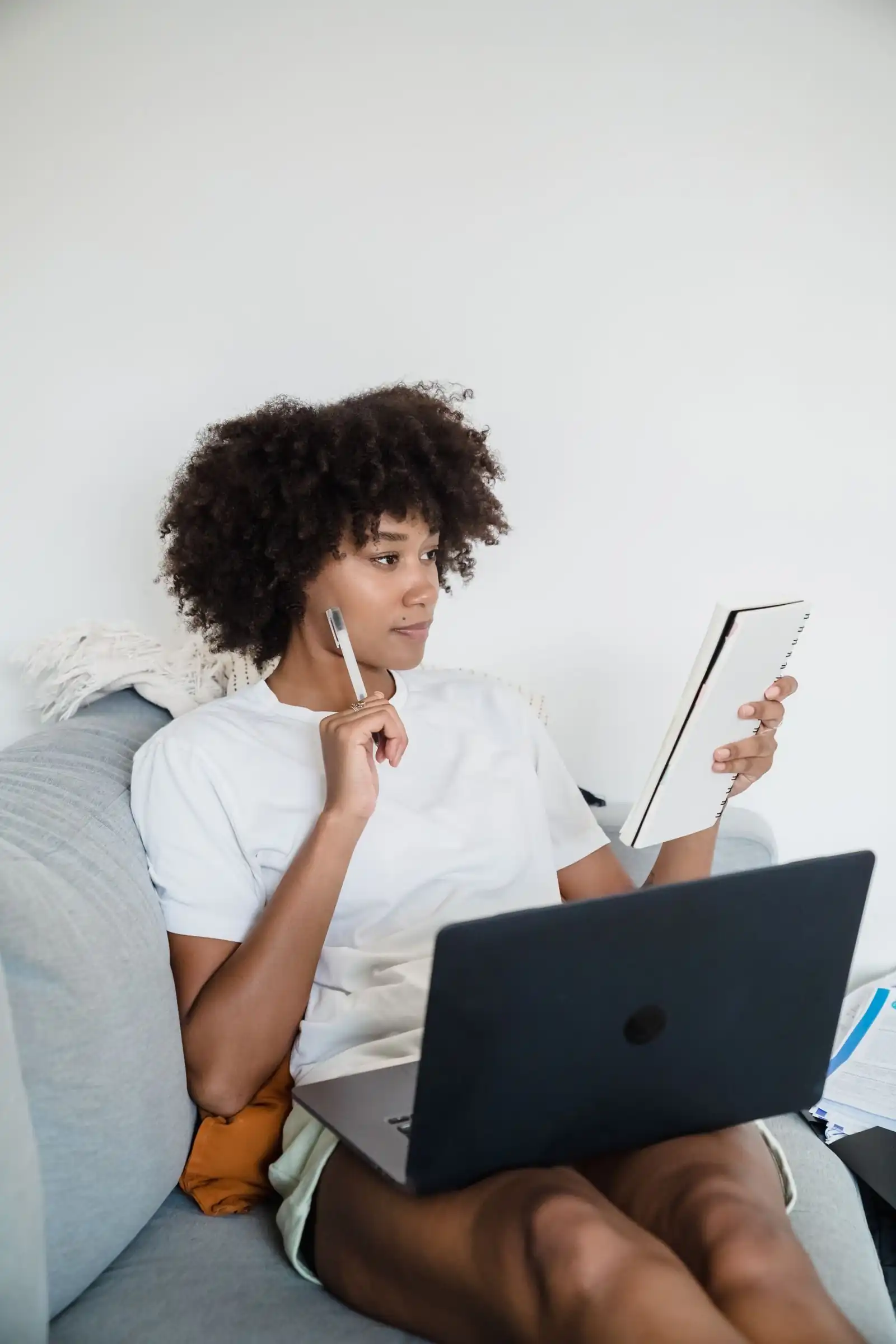 Two young women studying together online