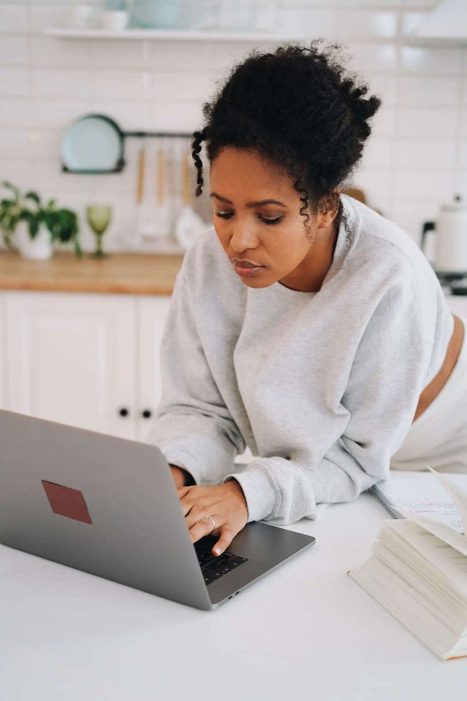 A young woman studying online on her laptop